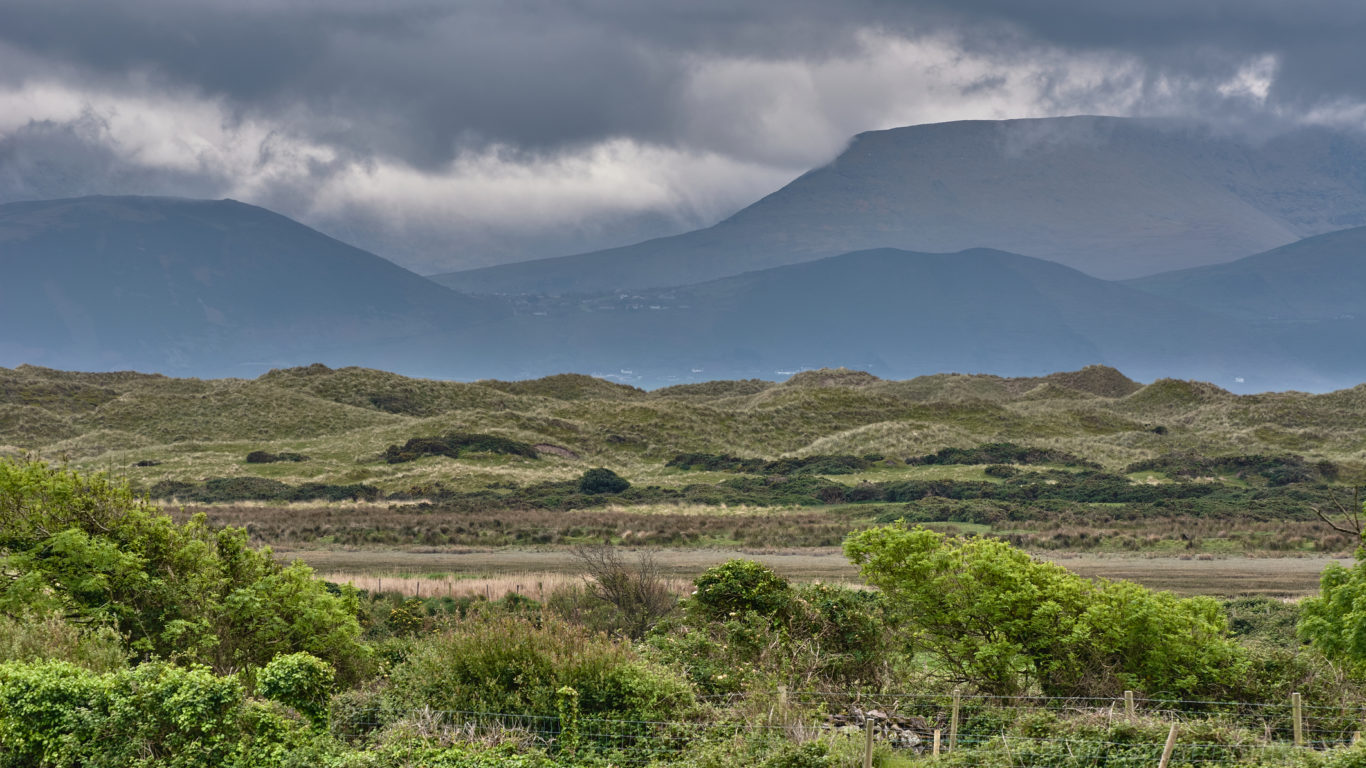 beautiful-panoramic-landscape-on-dingle-peninsula-ireland-panoramic-dune-landscape-with-mountain-silhouettes-and-dark-rain-198040166