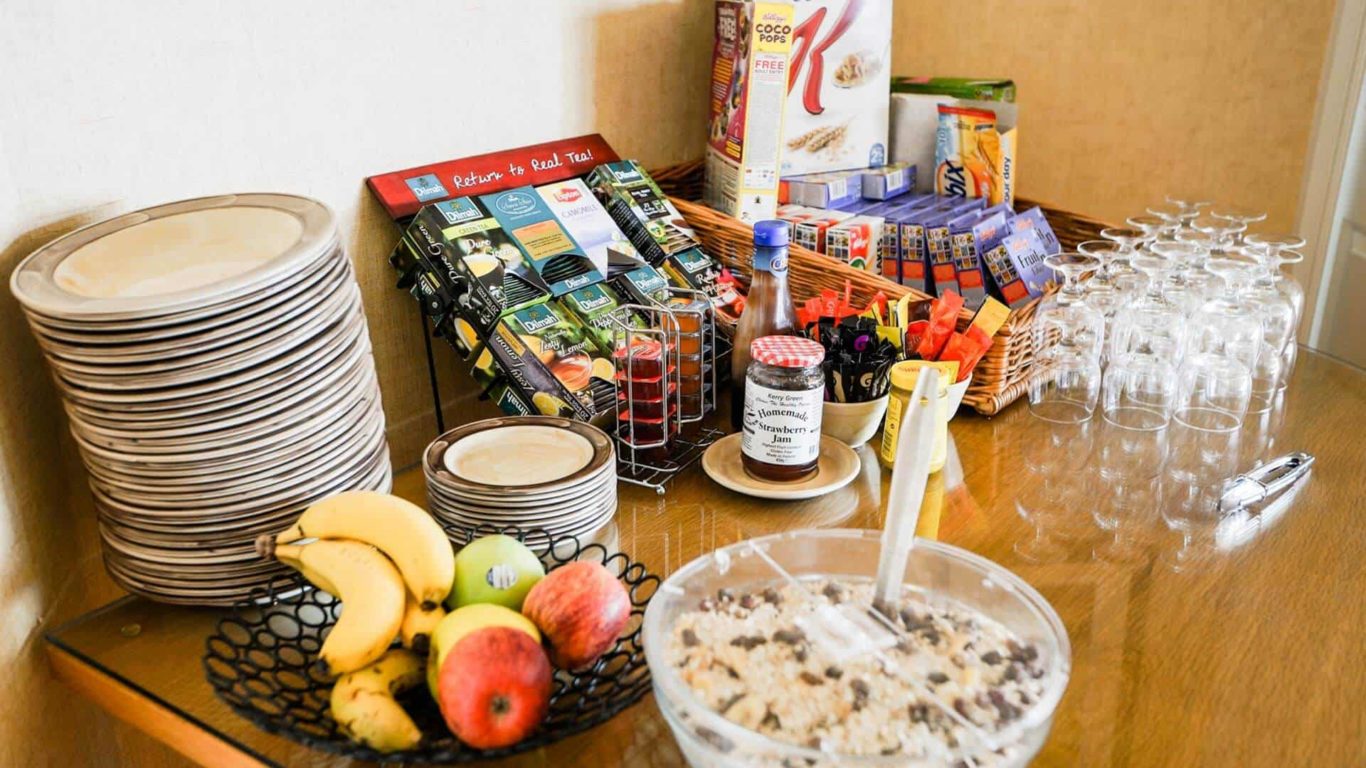 Enjoy a delightful breakfast buffet with fresh fruit, cereals, assorted teas, and pastries at our inviting hotel.